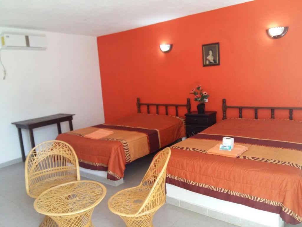 Postel nebo postele na pokoji v ubytování Hotel Playa Krystal