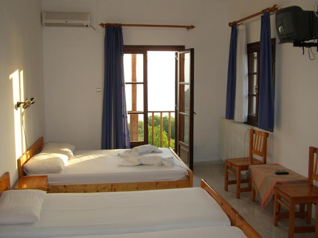 Postel nebo postele na pokoji v ubytování Hotel Tsagarada