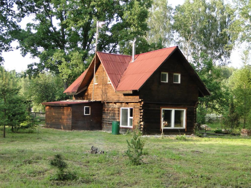 a small wooden house with a red roof at Country House Lesnaya 14 in Dubrava