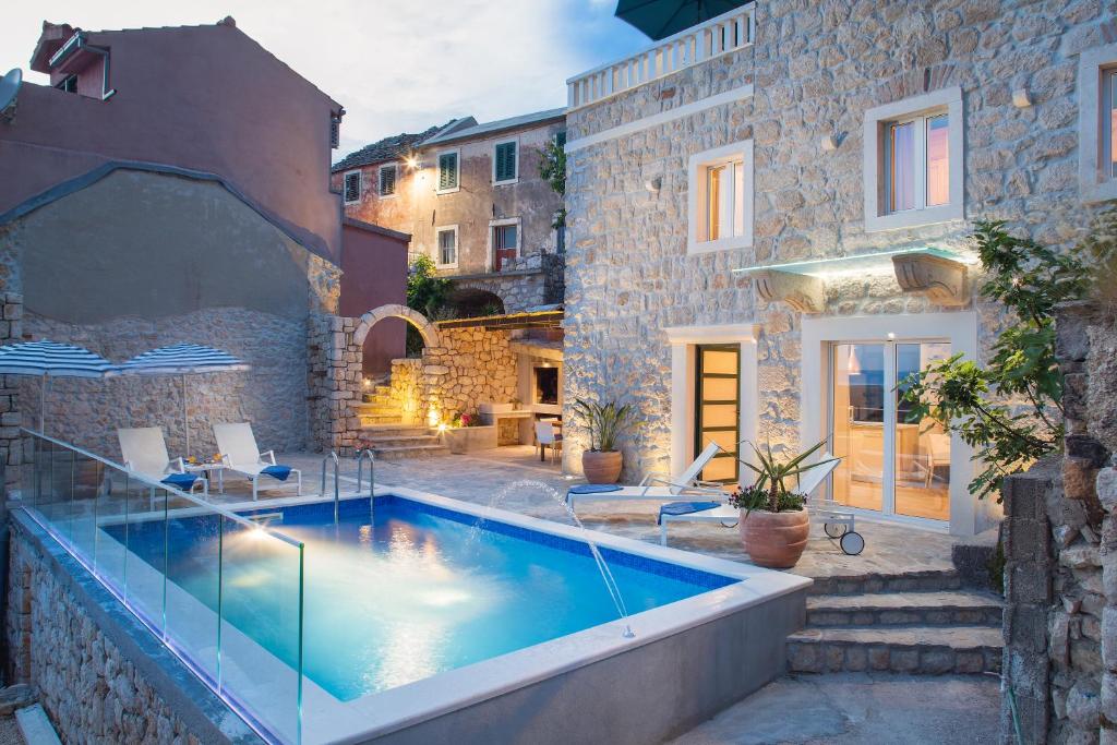 a house with a swimming pool in a yard at Villa Toni in Makarska