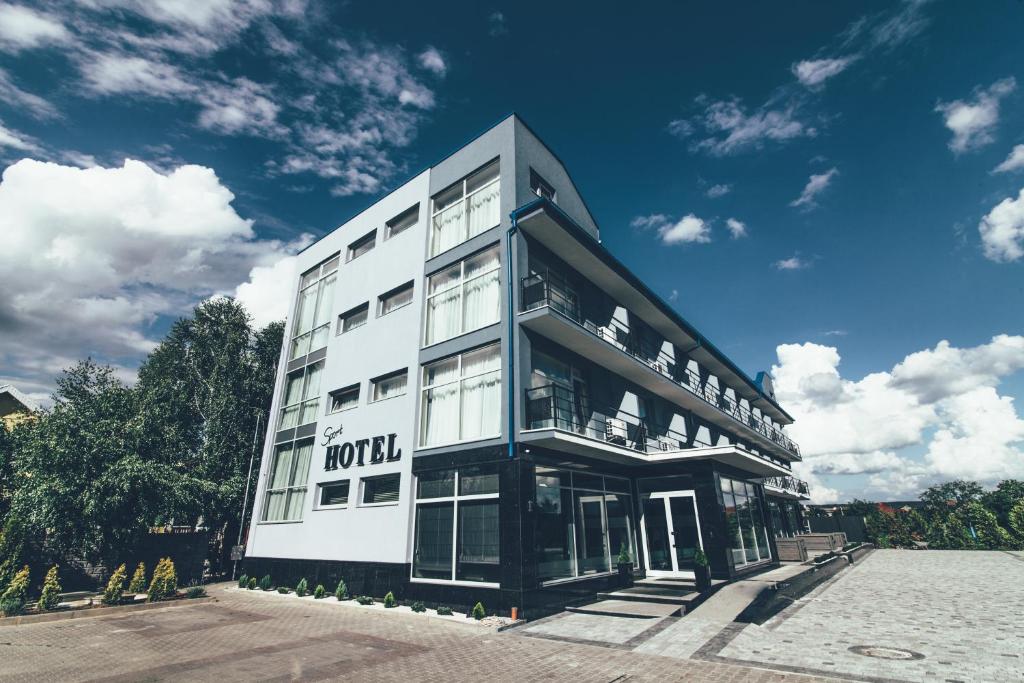 a large white building with a lot of windows at Zinedine Sport-Hotel in Uzhhorod