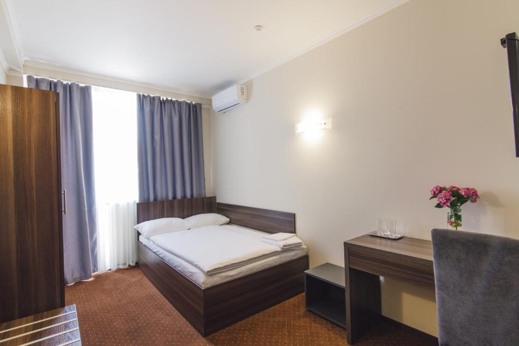 Postel nebo postele na pokoji v ubytování Zinedine Sport-Hotel