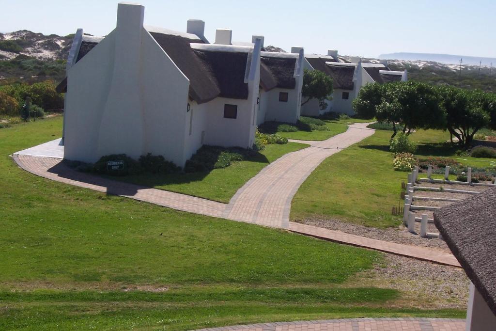a house with a path leading to a building at Draaihoek Lodge & Restaurant in Elands Bay