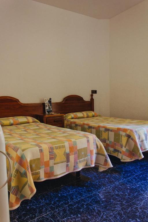 Postel nebo postele na pokoji v ubytování Hostal Noria