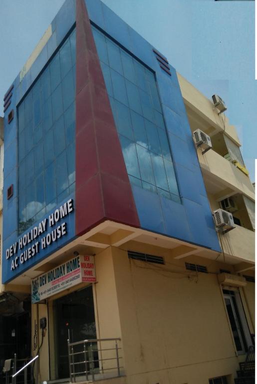 a building with a sign on the side of it at Devholiday Home in Sawāi Mādhopur