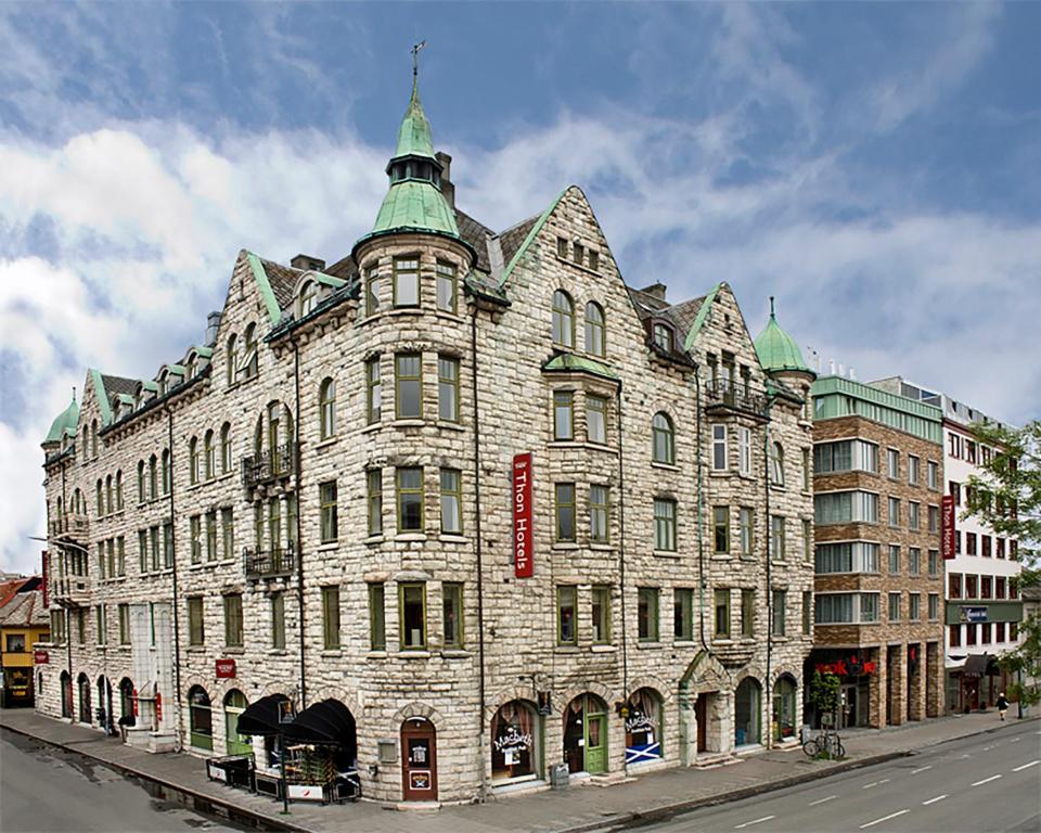 un grand bâtiment en pierre sur le côté d'une rue dans l'établissement Thon Hotel Nidaros, à Trondheim