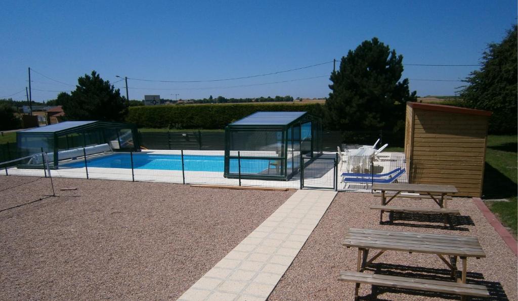 a swimming pool with a pavilion and a picnic table at L'Escale de la Baie de Somme in Le Crotoy