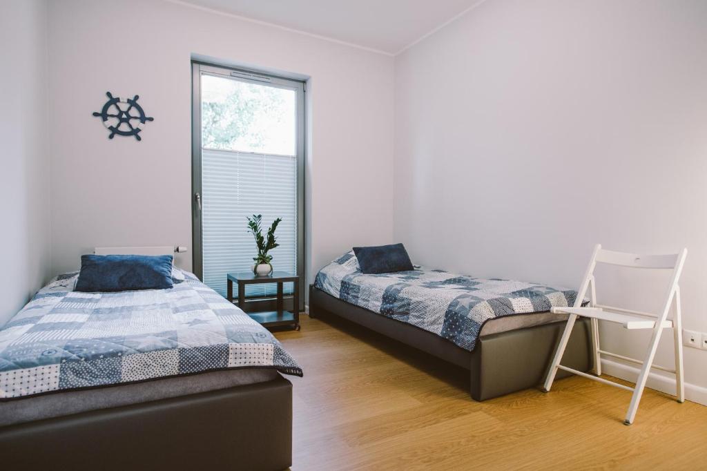 Posteľ alebo postele v izbe v ubytovaní Apartamenty Rodzina nad morzem