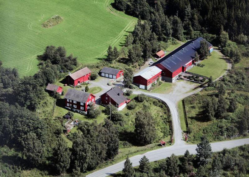 an aerial view of a farm with red buildings at Nedre Berg Gard in Lillehammer