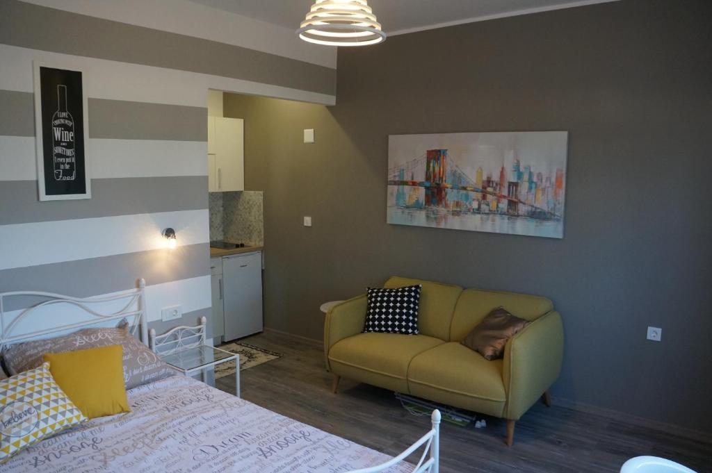 a living room with a couch and a bed at Apartments Valentino in Rab