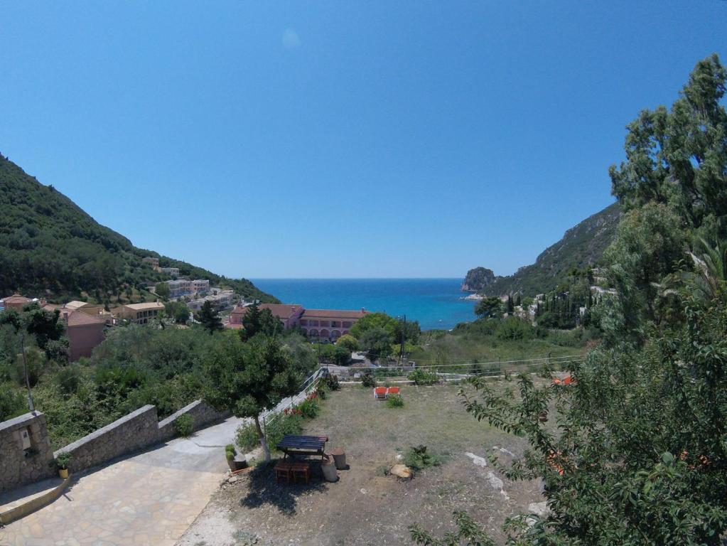 a view of a park with the ocean in the background at George's Studios in Ermones