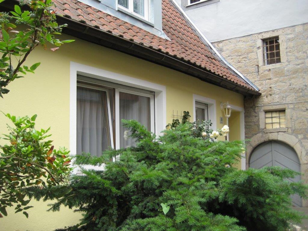 a yellow house with trees in front of it at Haus Gartentraum in Sommerhausen