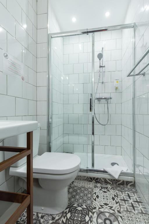 a bathroom with a toilet and a shower at Florella Marceau Apartment in Cannes