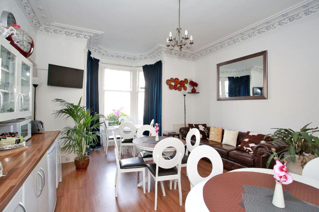 a kitchen and living room with a table and chairs at CitiHouse Aberdeen West End in Aberdeen