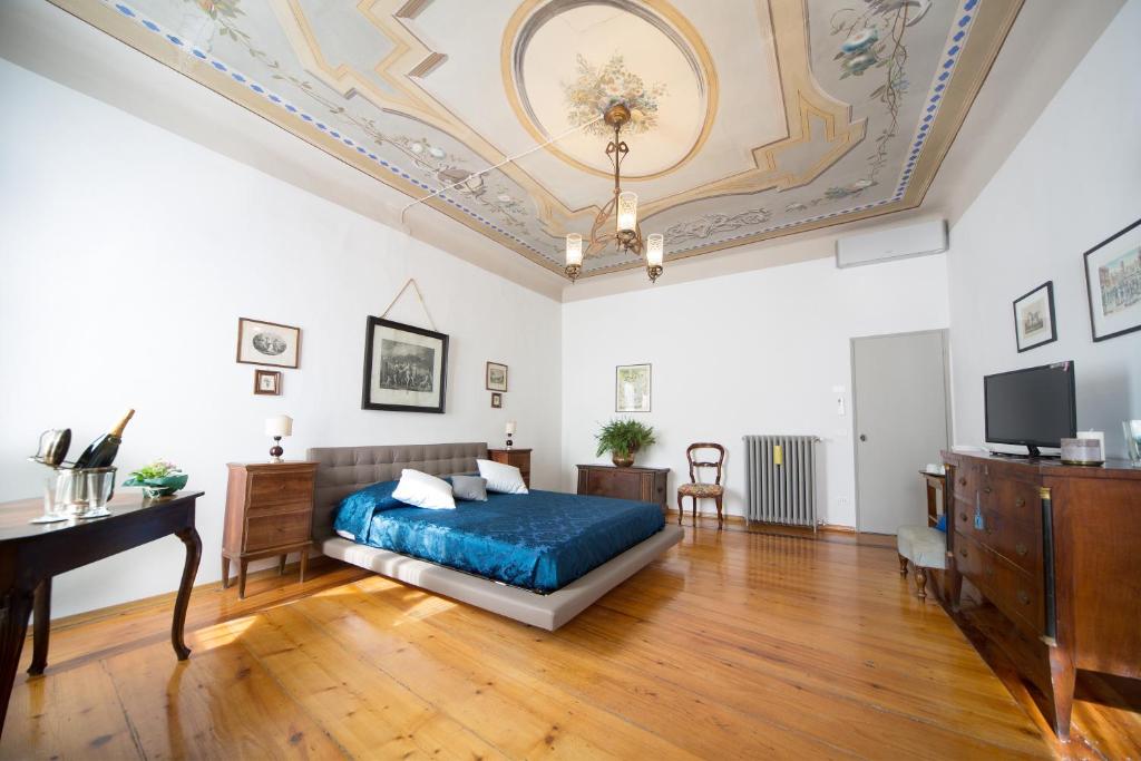 a bedroom with a blue bed and a piano at San Giacomo Bed & Breakfast in Verona
