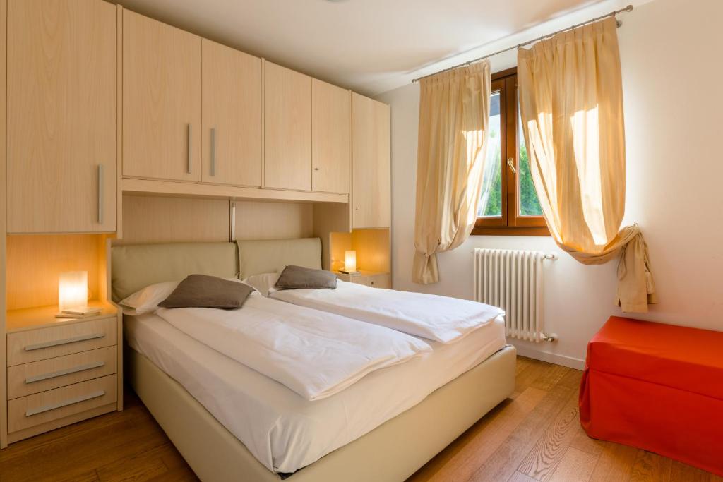 Postel nebo postele na pokoji v ubytování Residence Rta La Rosa delle Dolomiti