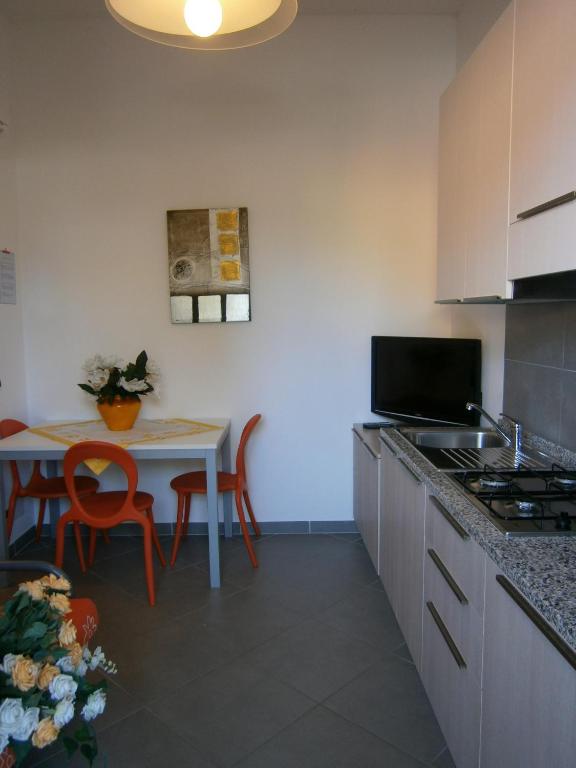 a kitchen with a table and a dining room at Quadrangolo in Bibione