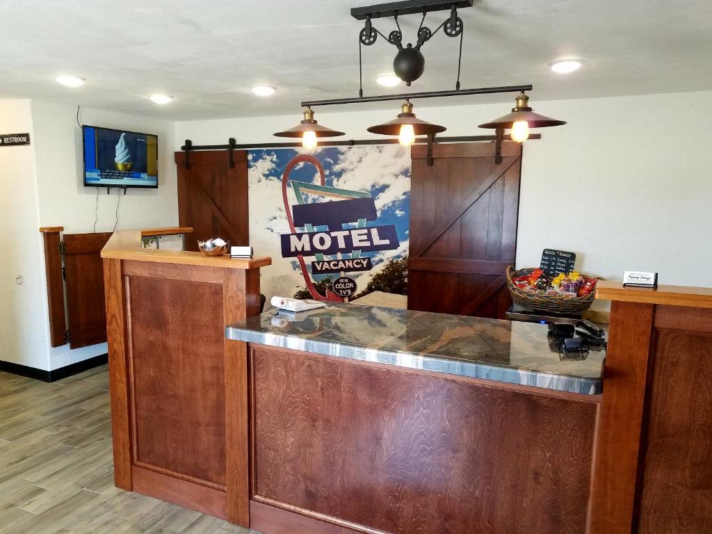 a restaurant counter with a hotel sign on the wall at West Plains Motel in West Plains