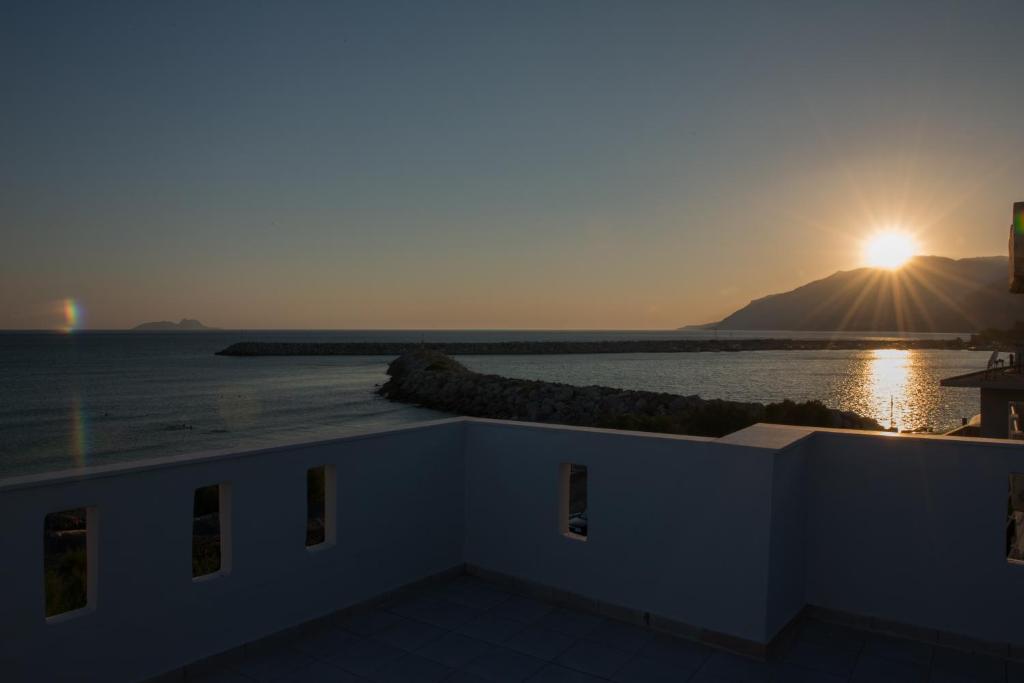a view of the sun setting over the ocean at Golden Sun in Kókkinos Pírgos