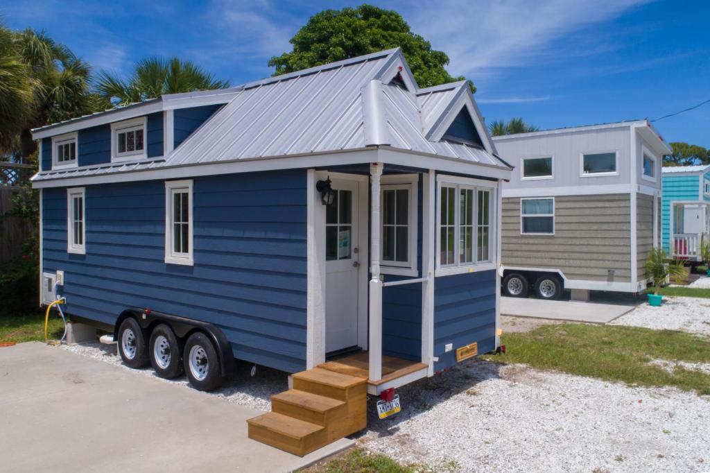 a blue tiny house parked in a driveway at Tiny House Siesta in Sarasota