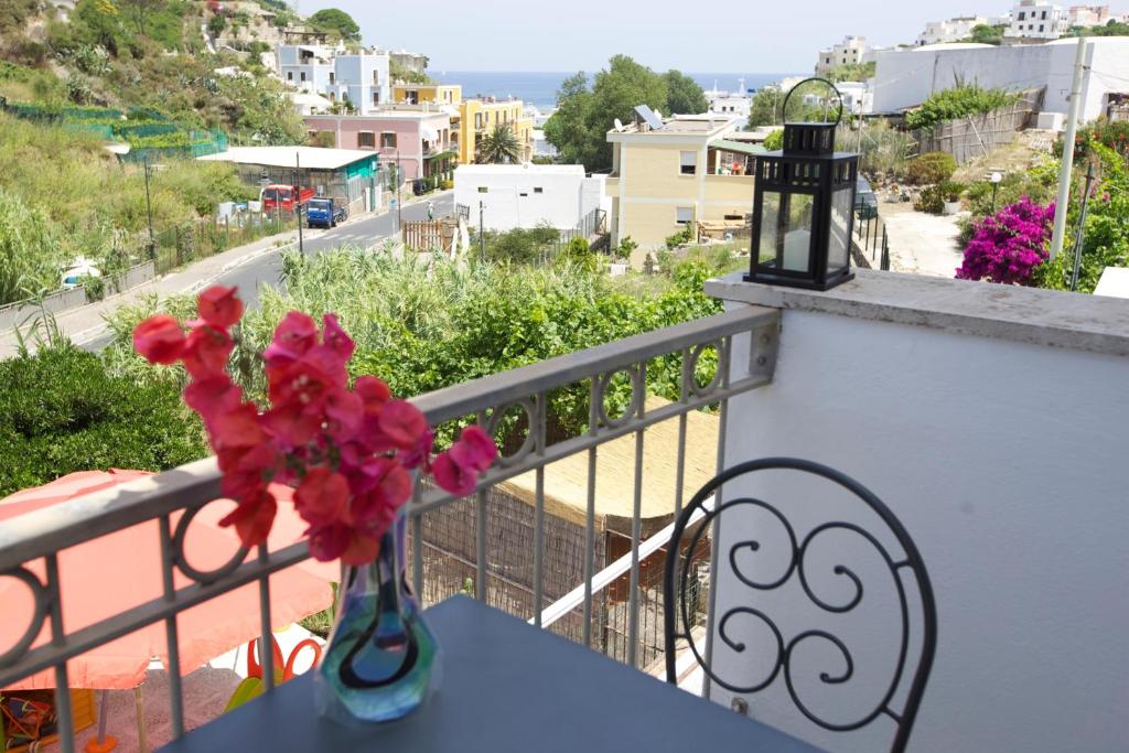 a vase of flowers sitting on a table on a balcony at Casa Baia Luna in Ponza