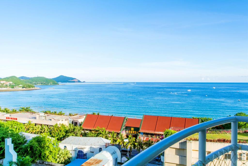 a view of the ocean from the balcony of a resort at Sanya Wen Xin Hai Jing Apartement in Sanya