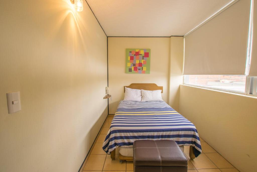 Postel nebo postele na pokoji v ubytování Hotel Mateos 1215