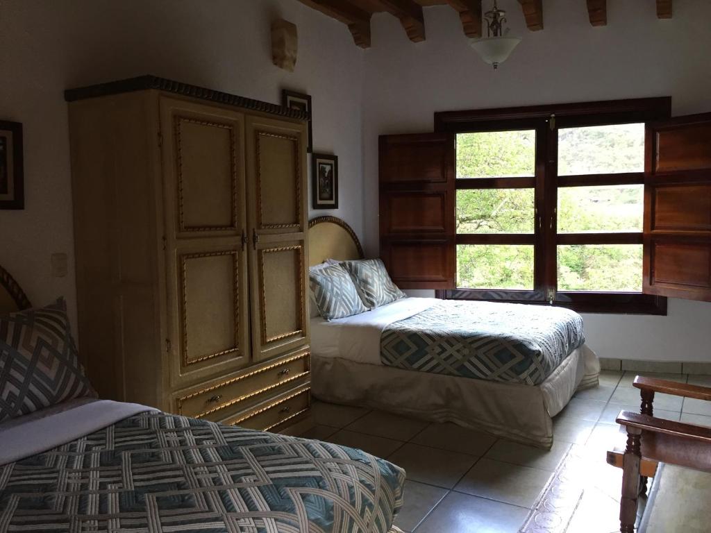 Postel nebo postele na pokoji v ubytování Hotel Mansion Real