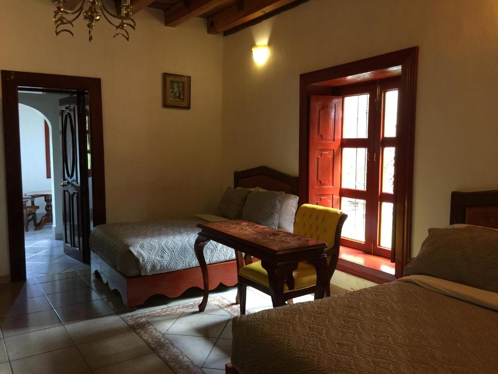 Postel nebo postele na pokoji v ubytování Hotel Mansion Real