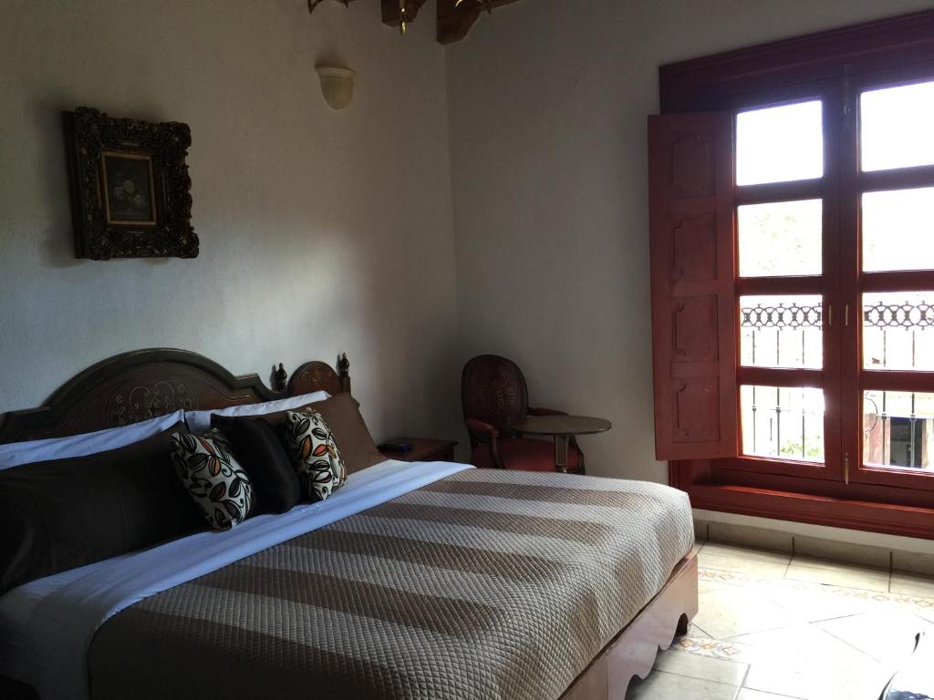 Postel nebo postele na pokoji v ubytování Hotel Mansion Real