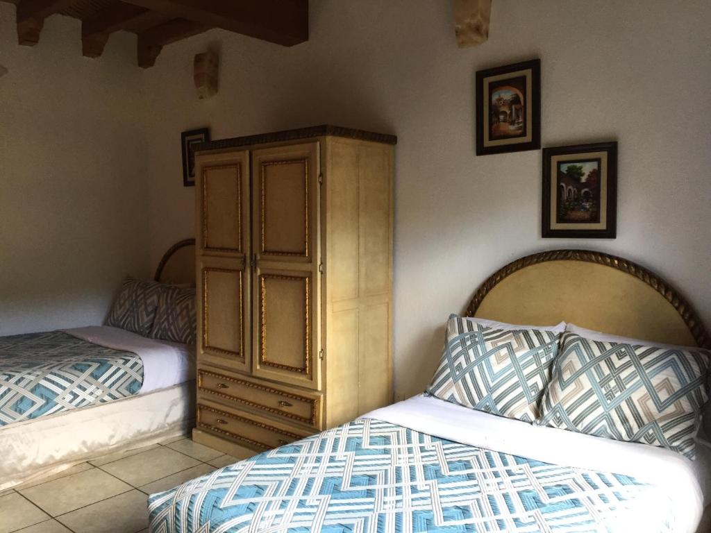 Postel nebo postele na pokoji v ubytování Hotel Mansion Real