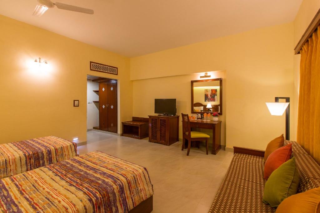 Postel nebo postele na pokoji v ubytování Viva Hotel Near Madgaon Railway Station