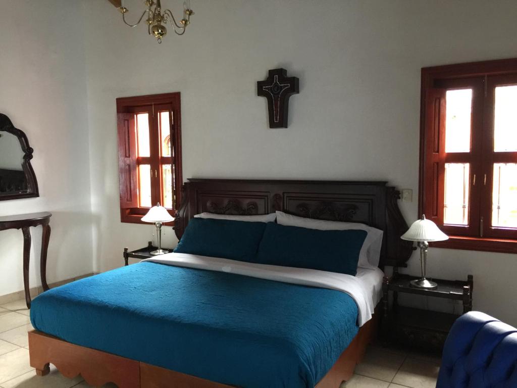 Postel nebo postele na pokoji v ubytování Hotel Mansion Real