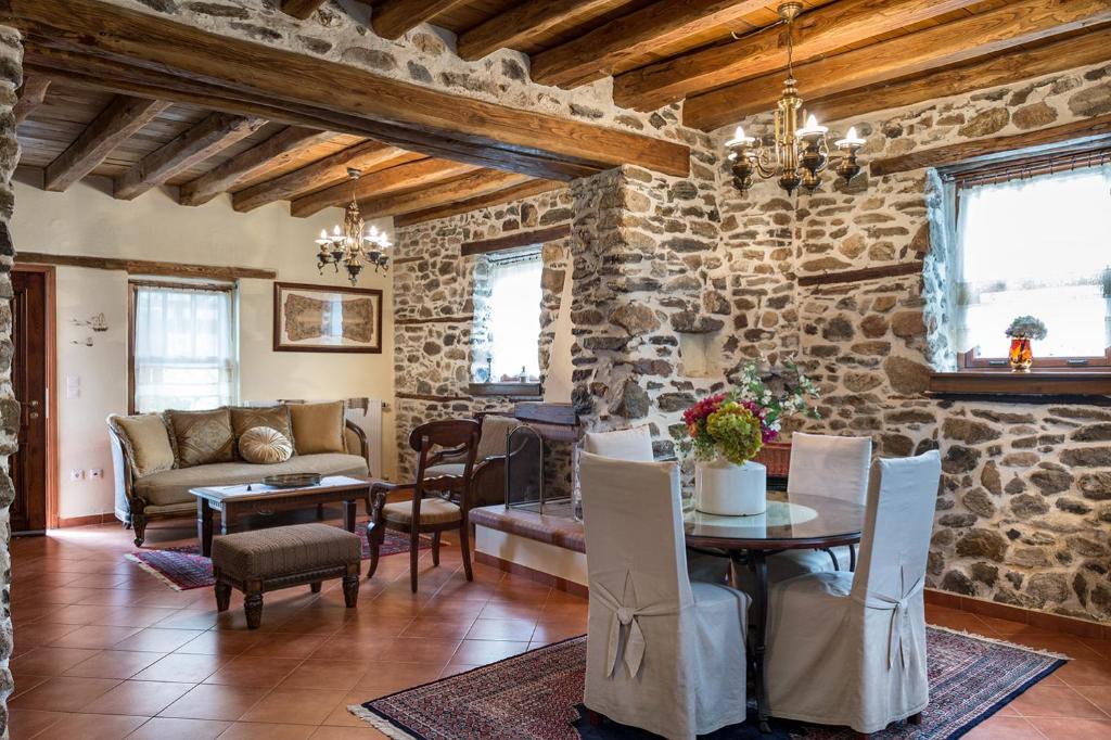 a living room with a stone wall at Premium Stone House in Vrasná