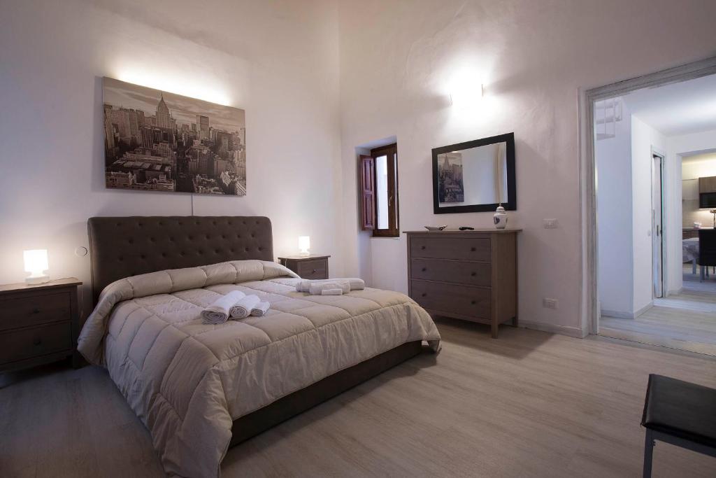 a bedroom with a large bed and two night stands at Residence Damarete in Syracuse