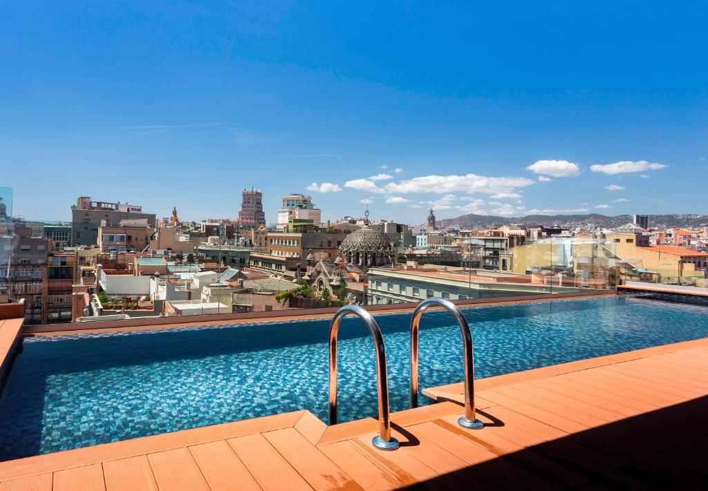 a swimming pool on the roof of a building at Negresco Princess 4* Sup in Barcelona