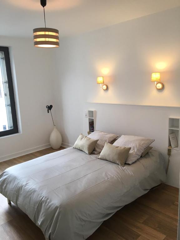 モントリシャールにあるPassage du Saumonのベッドルーム1室(大きな白いベッド1台、枕2つ付)