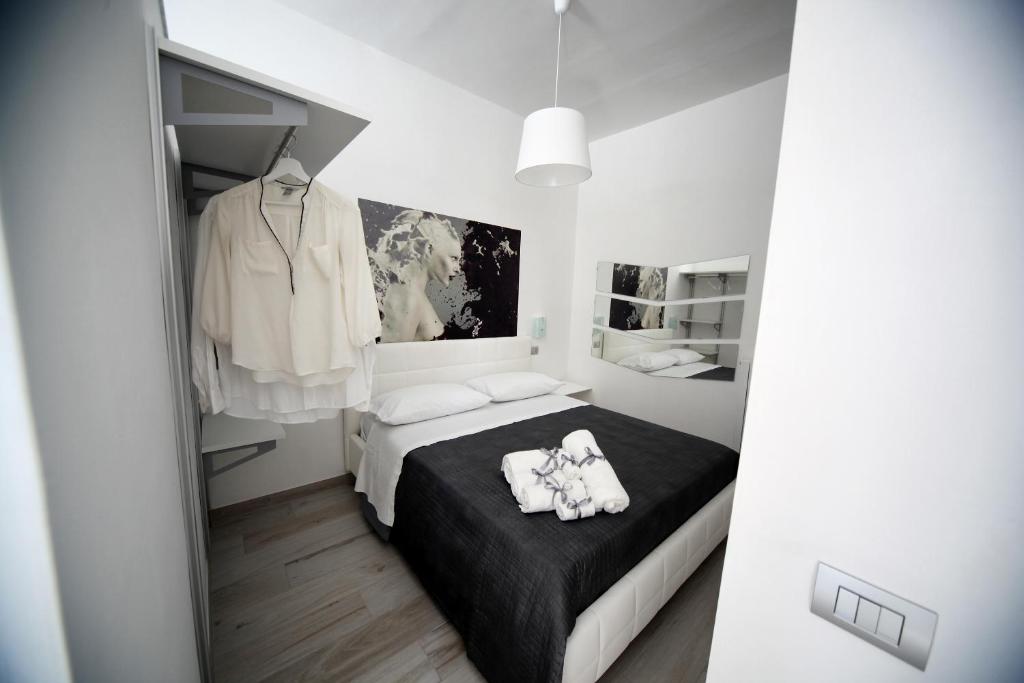 a bedroom with a bed with two white towels on it at SOHO Suite in Fisciano