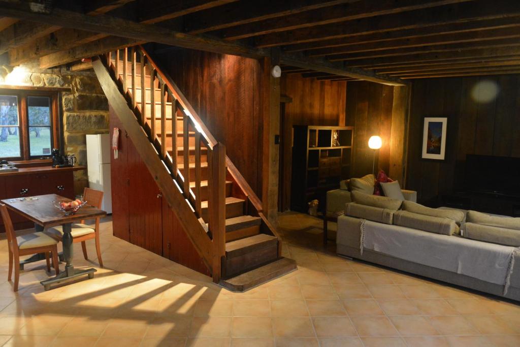 een woonkamer met een trap en een bank bij Thulanathi - Rest Explore Reconnect in Pokolbin