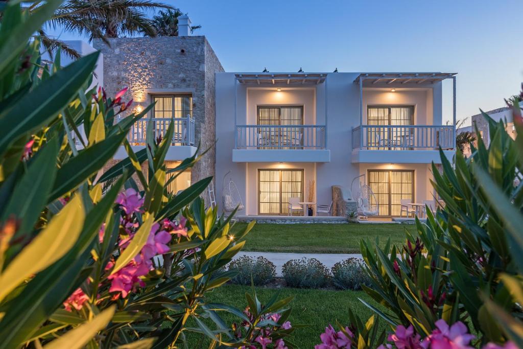 a view of a house from the garden at dusk at White Pearls-Adults Only Luxury Suites in Kos Town