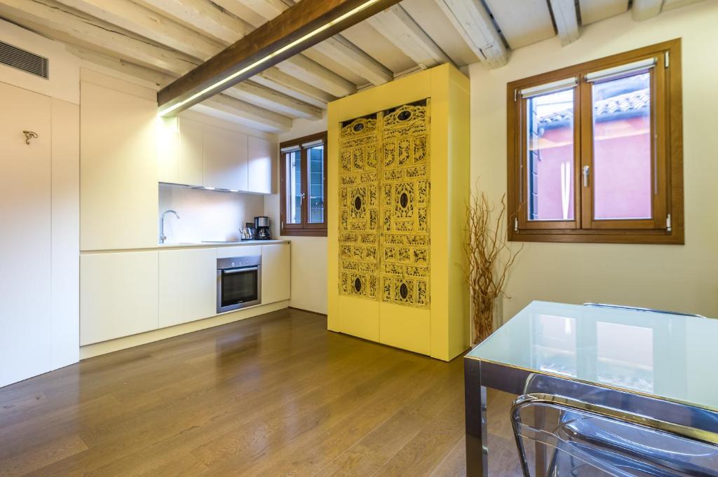 a kitchen with a yellow door and a table at Apartments Moon or Dama in Venice