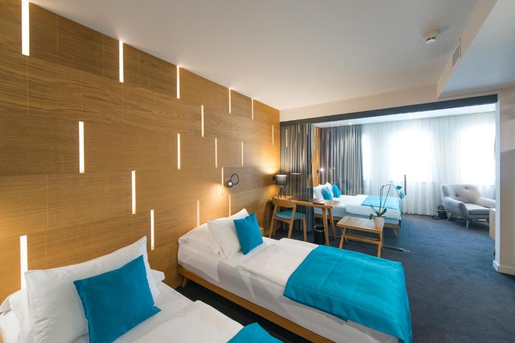 Postel nebo postele na pokoji v ubytování Hotel Sana