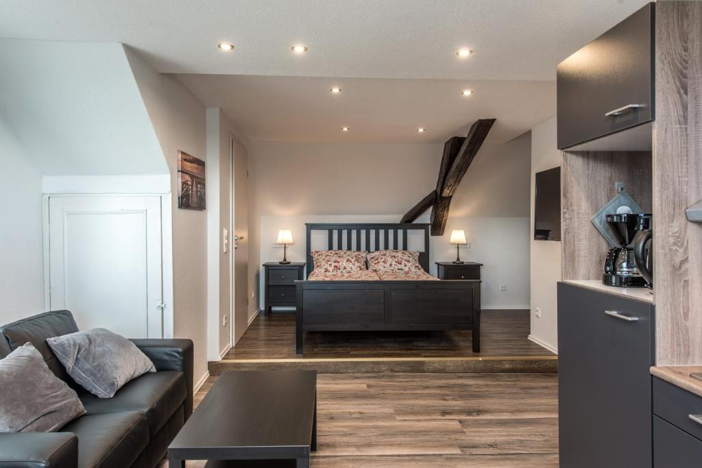 a living room with a bed and a couch at Ferienwohnung Kopf in Bad Buchau