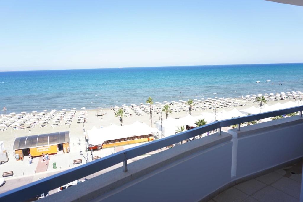 a view of a beach with chairs and the ocean at Lazuli Sea View Beachfront Ap 43 in Larnaka