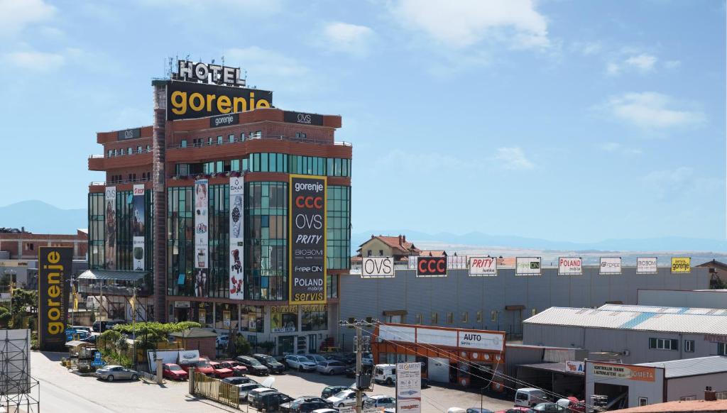 a large building with a clock on the side of it at Hotel Gorenje in Prishtinë