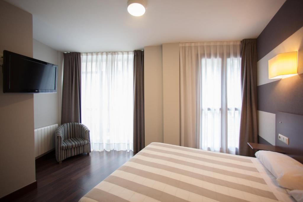 Postel nebo postele na pokoji v ubytování Hotel Sirimiri