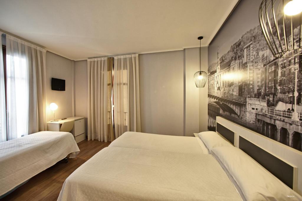 Postel nebo postele na pokoji v ubytování Hotel Sirimiri
