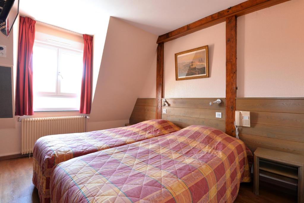 Postel nebo postele na pokoji v ubytování Hotel Restaurant Dontenville
