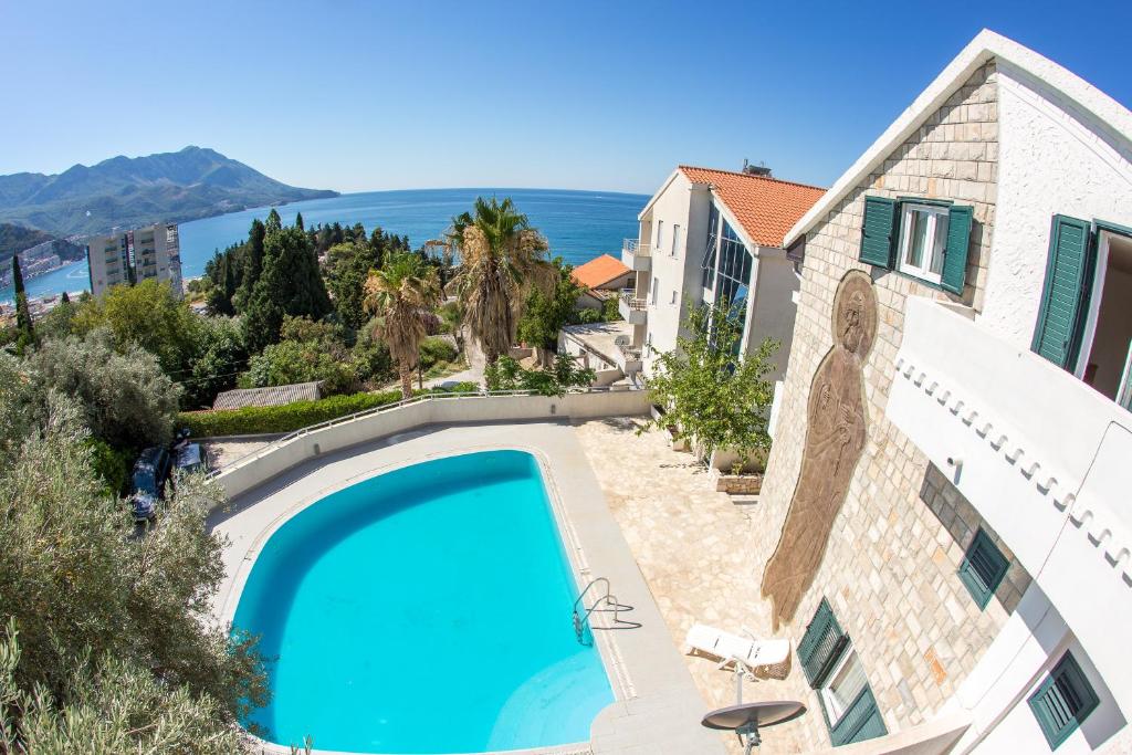 a swimming pool in front of a house at The Turtles Garden in Bečići