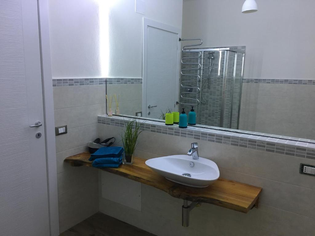 a bathroom with a sink and a mirror at guest house for you in Modena